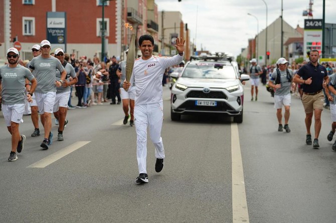 ‘An achievement for all Arabs’: PSG President Nasser Al-Khelaifi takes part in Olympic Torch Relay in Paris ahead of opening ceremony