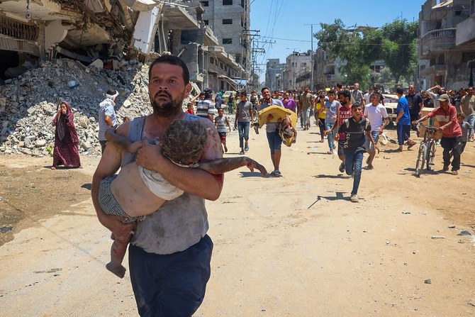 People carry children injured during Israeli bombardment as people flee at the Al-Bureij refugee camp in the central Gaza Strip 