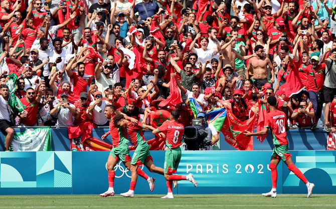 Morocco fans rush field during Olympic football opener versus Argentina. Game suspended, goal disallowed