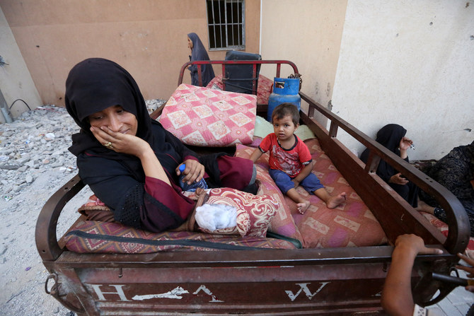 Displaced Palestinians, who fled their houses due to Israeli strikes, take shelter, in Khan Younis in the southern Gaza Strip.