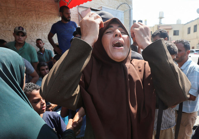 A Palestinian woman reacts following an Israeli strike, amid the Israel-Hamas conflict, at Al-Aqsa Martyrs Hospital.