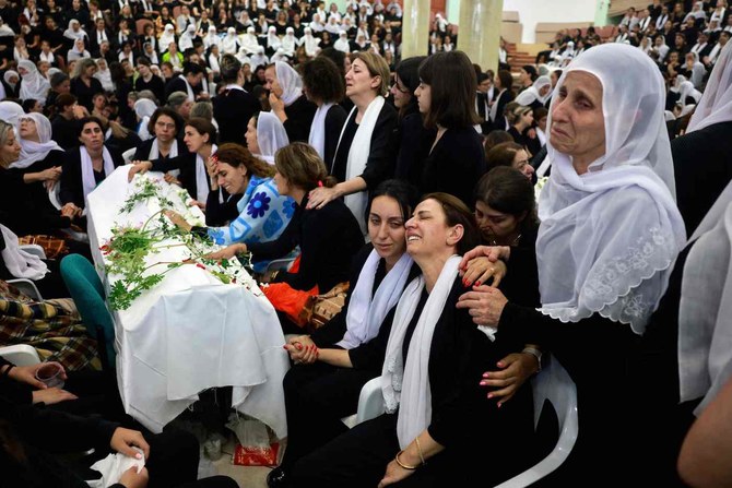 Druze women mourn by a coffin during a funeral of a person killed in a rocket strike from Lebanon a day earlier in Golan Heights