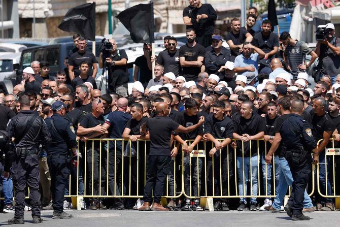 Israeli security hold back demonstrators during a visit by the Israeli prime minister.