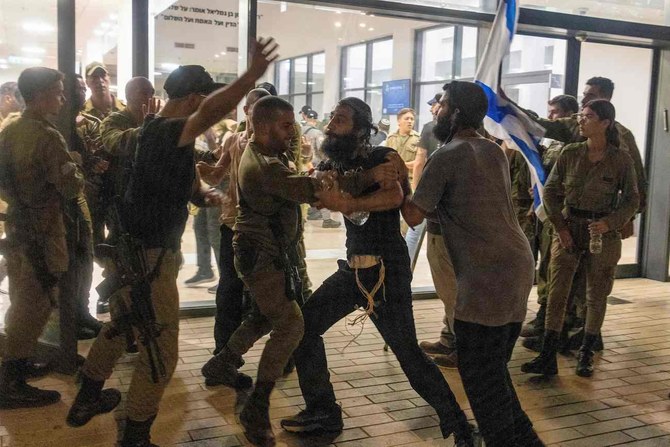 Israeli soldiers clash with right wing protesters, after they broke into the Bayt Lid army base.