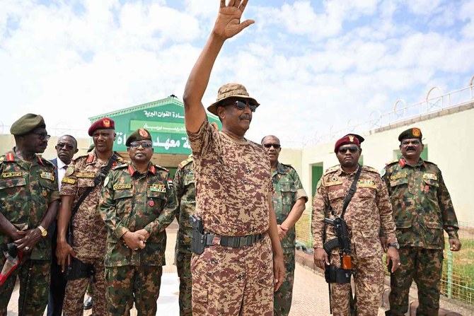 Sudan’s army chief Abdel Fattah Al-Burhan (C) waves during a graduation ceremony in Gibet near Port Sudan on July 31, 2024. (AFP