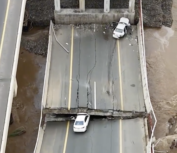 Al-Ekhbariya aired images of two vehicles caught up in the floodwaters, one of them crushed by a collapsed bridge support.