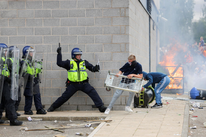A police officer clashes with a protestor outside a hotel in Rotherham, Britain, August 4, 2024. (Reuters)