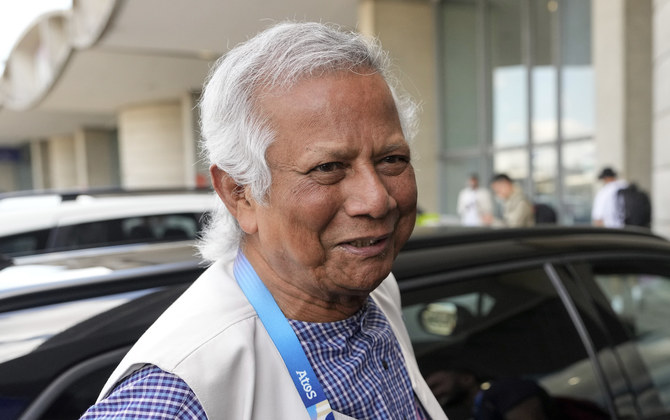 Nobel laureate Muhammad Yunus smiles upon his arrival at Charles de Gaulle’s airport in Roissy, north of Paris. (AP)