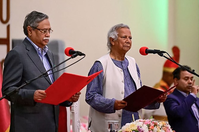 Nobel laureate Muhammad Yunus (C) takes the oath of office as the chief adviser of Bangladesh’s new interim government in Dhaka.