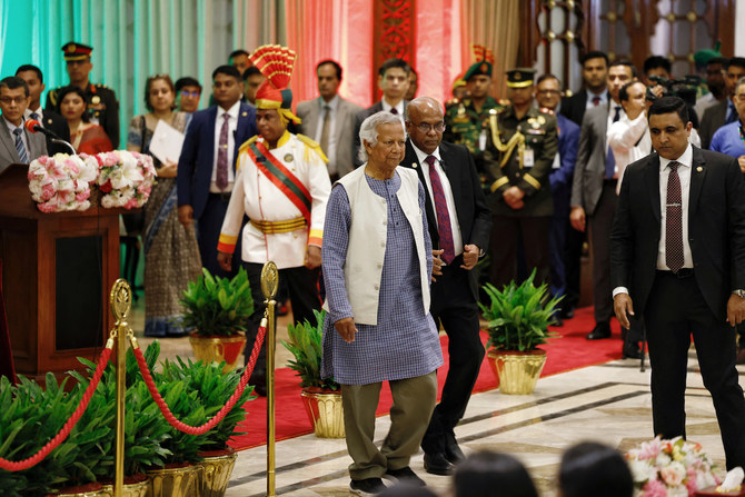 Muhammad Yunus walks off the stage after taking oath at the Bangabhaban as head of the interim government, in Dhaka, Bangladesh.