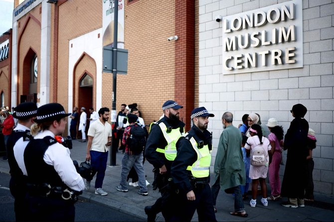 Police officers stand guard outside the East London Mosque after Friday prayers in Tower Hamlets in London on August 9, 2024.