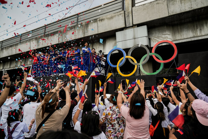 Filipino gymnast Carlos Yulo joins a welcoming parade for Filipino athletes who competed at the Paris 2024 Olympics, in Manila.