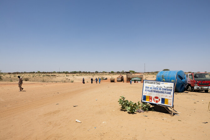 People cross the border between Sudan and Chad at the border post in Adre. (File/AFP)