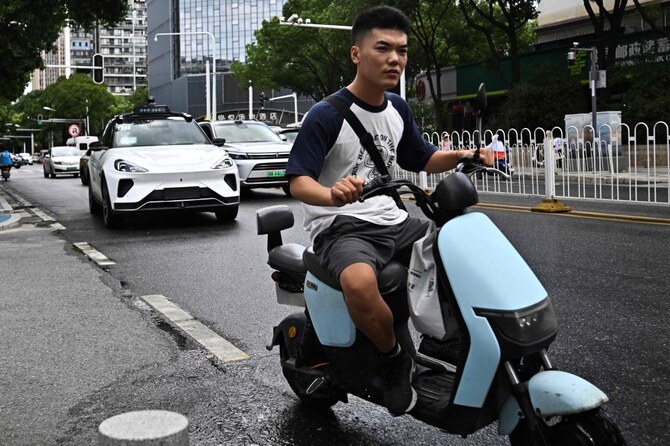 China’s growing ‘robotaxi’ fleet sparks concern, wonder on streets