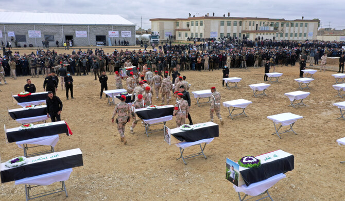 Mourners prepare to bury the remains of Yazidi victims in a cemetery in Sinjar, Iraq, Saturday, Feb. 6, 2021. (AP)