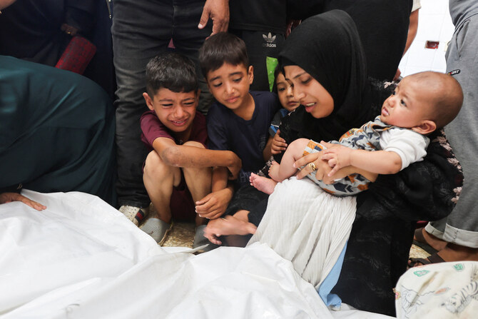 Mourners react next to the bodies of Palestinians killed in Israeli strikes at Al-Aqsa Martyrs Hospital in Deir Al-Balah.