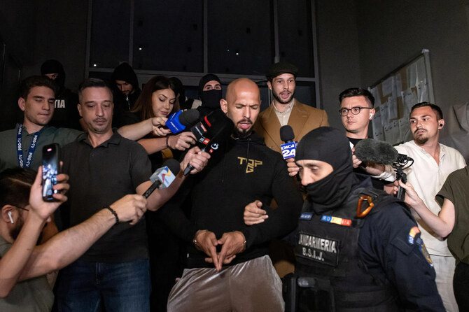 Andrew Tate and his brother Tristan are escorted outside the Directorate for Investigating Organized Crime and Terrorism.