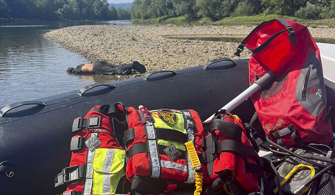 A body lies near the Drina River by the town of Bratunac, Bosnia, Thursday, Aug. 22, 2024. (AP)