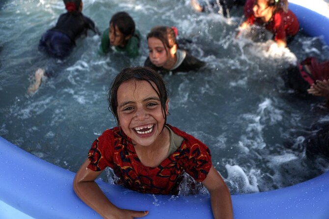 Mobile pools offer relief from heat to children in north Syria camps