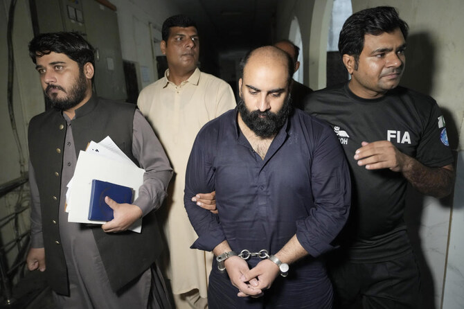 Farhan Asif is escorted by officials for his court appearance, in Lahore, Pakistan, Monday, Aug. 26, 2024. (AP)