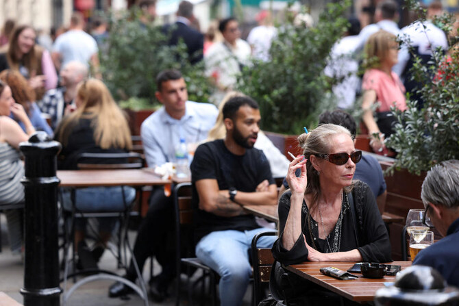 A woman smokes outside a pub in Covent Garden, London, Britain, August 29, 2024. (Reuters)