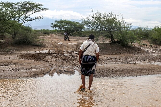 A man walks out of a flooded area following recent heavy flooding in the Hays region south of Yemen’s Hodeidah province.