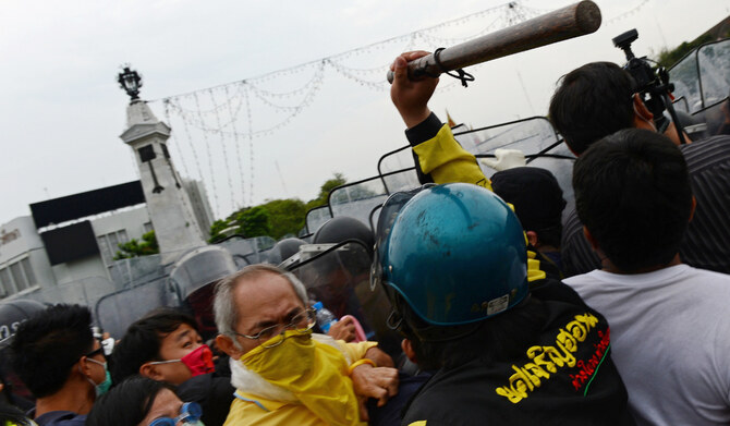 Thai anti-government protesters scuffle with a police during a protest in Bangkok on Saturday. (AFP)