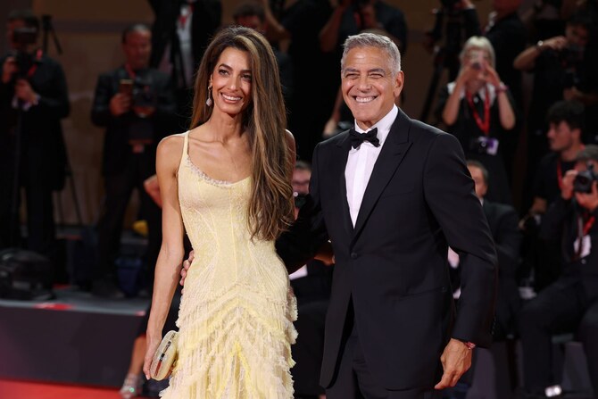 Amal and George Clooney walk the red carpet at ‘Wolfs’ premiere in Venice