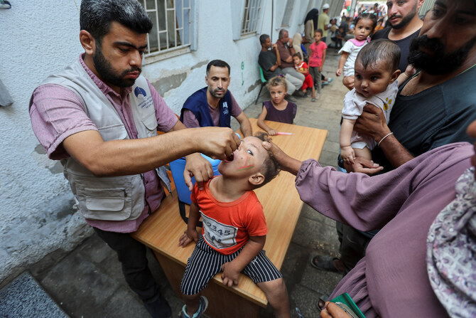 A Palestinian child is vaccinated against polio in Deir Al-Balah in the central Gaza Strip, September 4, 2024. (Reuters)