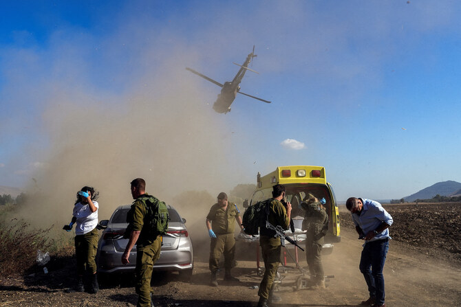 Israeli soldiers evacuate an injured man following a cross-border attack from Lebanon into Israel.