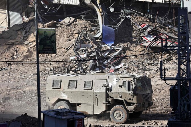 An Israeli armored vehicle drives along a devastated street in Jenin in the occupied West Bank on September 4, 2024.