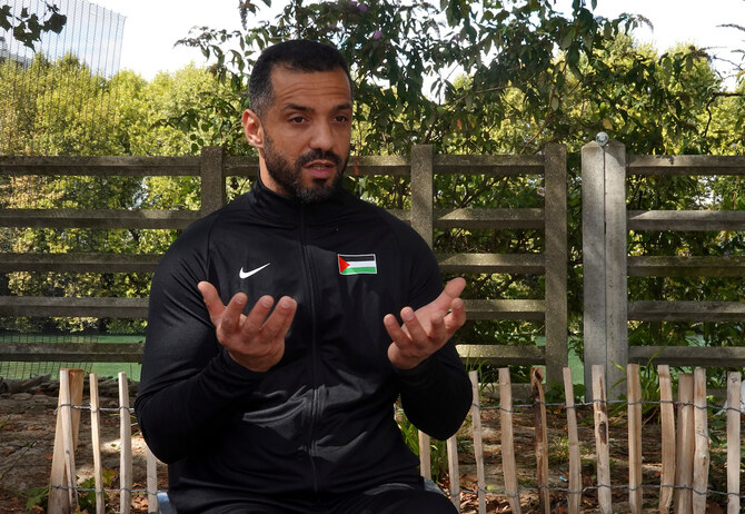 Palestinian Paralympic athlete Fadi Aldeeb talks during an interview outside the Paralympic village in Saint-Denis, France.