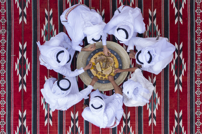 Saudi men enjoy a dish from Asia called Mashgouth. (Supplied)