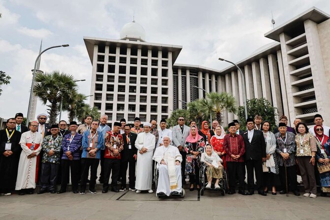 Pope Francis and Grand Imam of Istiqlal Mosque Nasaruddin Umar pose for a photo following an inter-religious gathering.