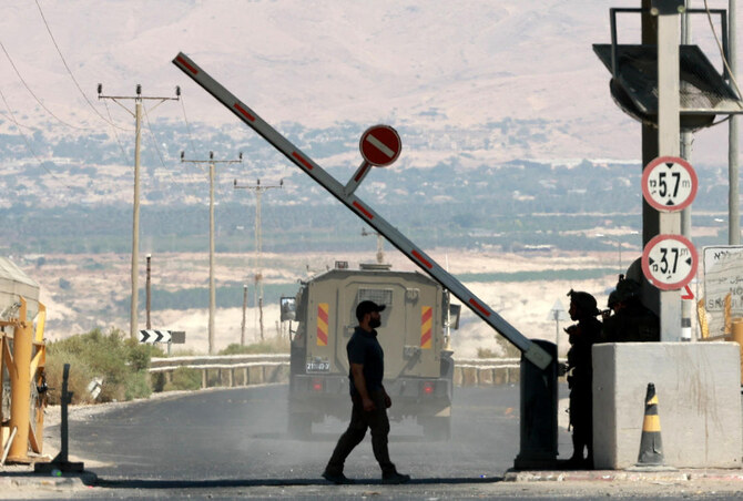 A man walks at a barrier, at the Allenby Bridge Crossing between the West Bank and Jordan.