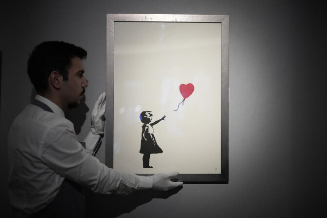 Two men charged with stealing a famous Banksy image from a London art gallery