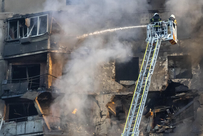 Firefighters tackle a blaze after a Russian aerial bomb struck a multi-story residential building in Kharkiv, Ukraine, Sunday.