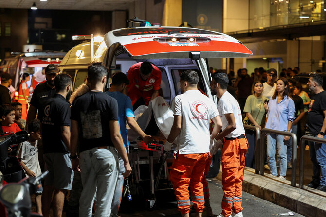 A person is carried on a stretcher outside American University of Beirut Medical Center.