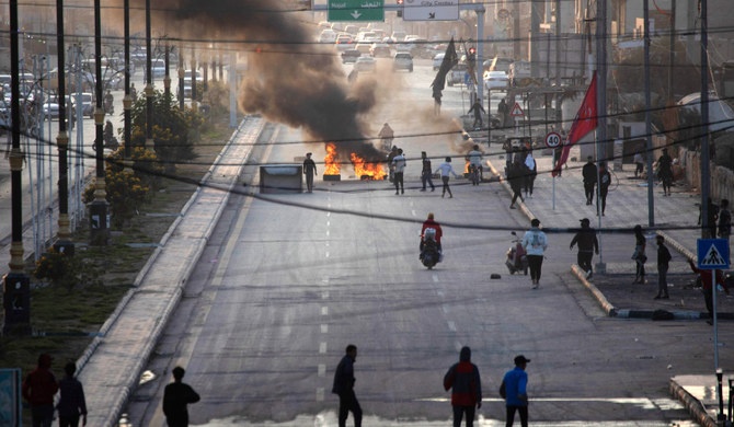 Iraqi demonstrators block a road with burning tyres as they protest the death of fellow protestors in Nasiriyah. (AFP)