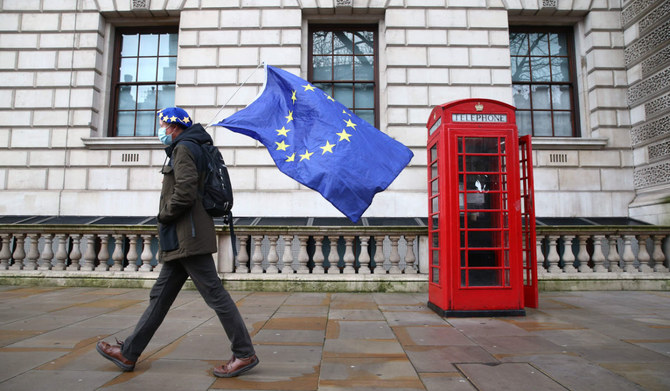 A man wearing an EU flag-themed beret and carrying an EU flag is seen on Whitehall in central London on December 11, 2020. (AFP)