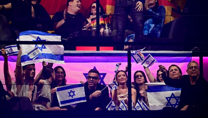 Singer Eden Golan (C) representing Israel and team members react as votes are counted at the final of Eurovision (AFP)