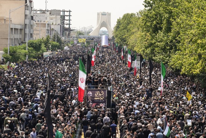 Mourners attend the funeral procession of Iran's President Ebrahim Raisi, in Tehran on May 22, 2024 (AFP)