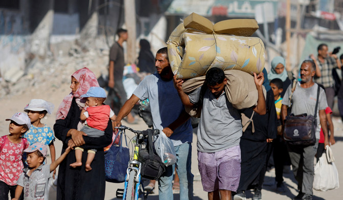 Displaced Palestinians make their way as they flee the eastern part of Khan Younis. (REUTERS)