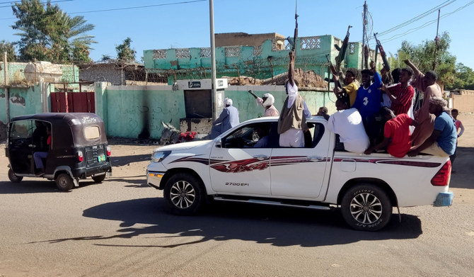 Armed Sudanese civilians wave weapons and chant slogans in eastern Sudan to express their support for the Army. (AFP)