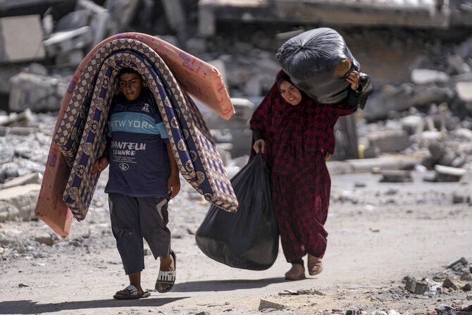 Palestinians displaced by the Israeli air and ground offensive on the Gaza Strip flee from Hamad City on Sunday, Aug. 11, 2024. 