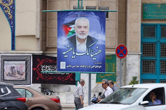 Traffic moves past a banner depicting Palestinian Hamas leader Ismail Haniyeh near Palestine Square in Tehran on August 12, 2024