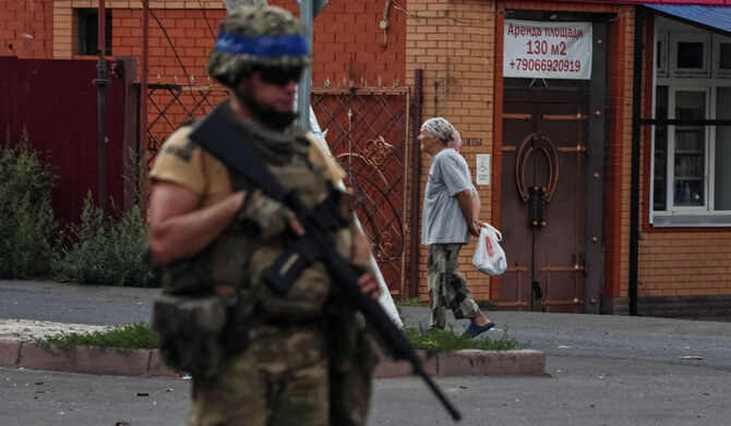 A Ukrainian serviceman patrols an area in the controlled by Ukrainian army town of Sudzha, Kursk region, Russia. (REUTERS)