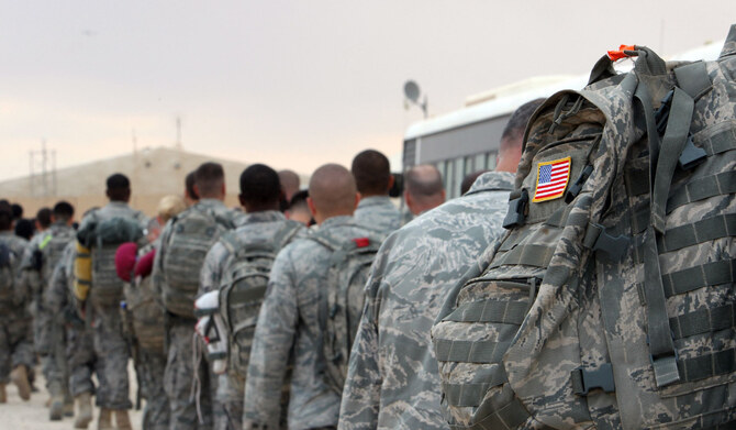 US army soldiers queue to board a plane to begin their journey home out of Iraq from the Al-Asad Air Base in Baghdad. (AFP)