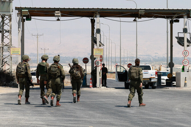 Israeli soldiers walk, at the Allenby Bridge Crossing between the West Bank and Jordan, following a shooting incident. (Reuters)