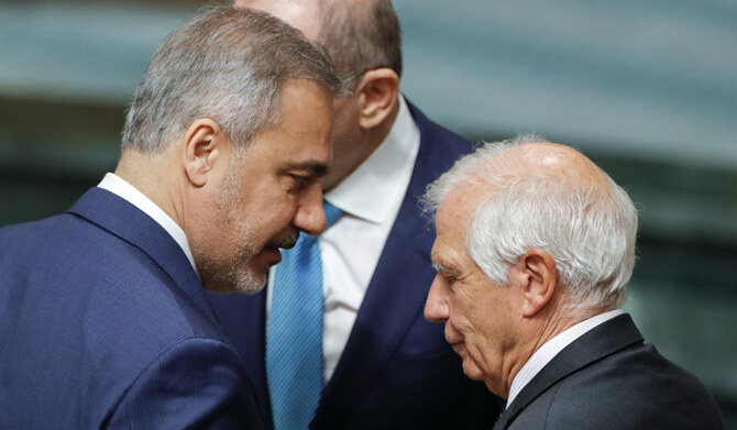 Turkish FM Hakan Fidan (L) speaks to EU foreign policy chief Josep Borrell during Arab foreign ministers meeting in Cairo. (AP)